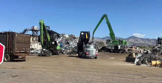Material handlers sorting scrap metal at the yard