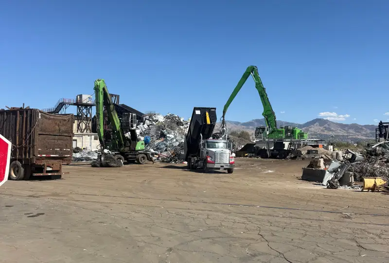 Material handlers sorting heavy scrap at the yard